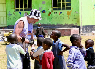 Col playing with the children